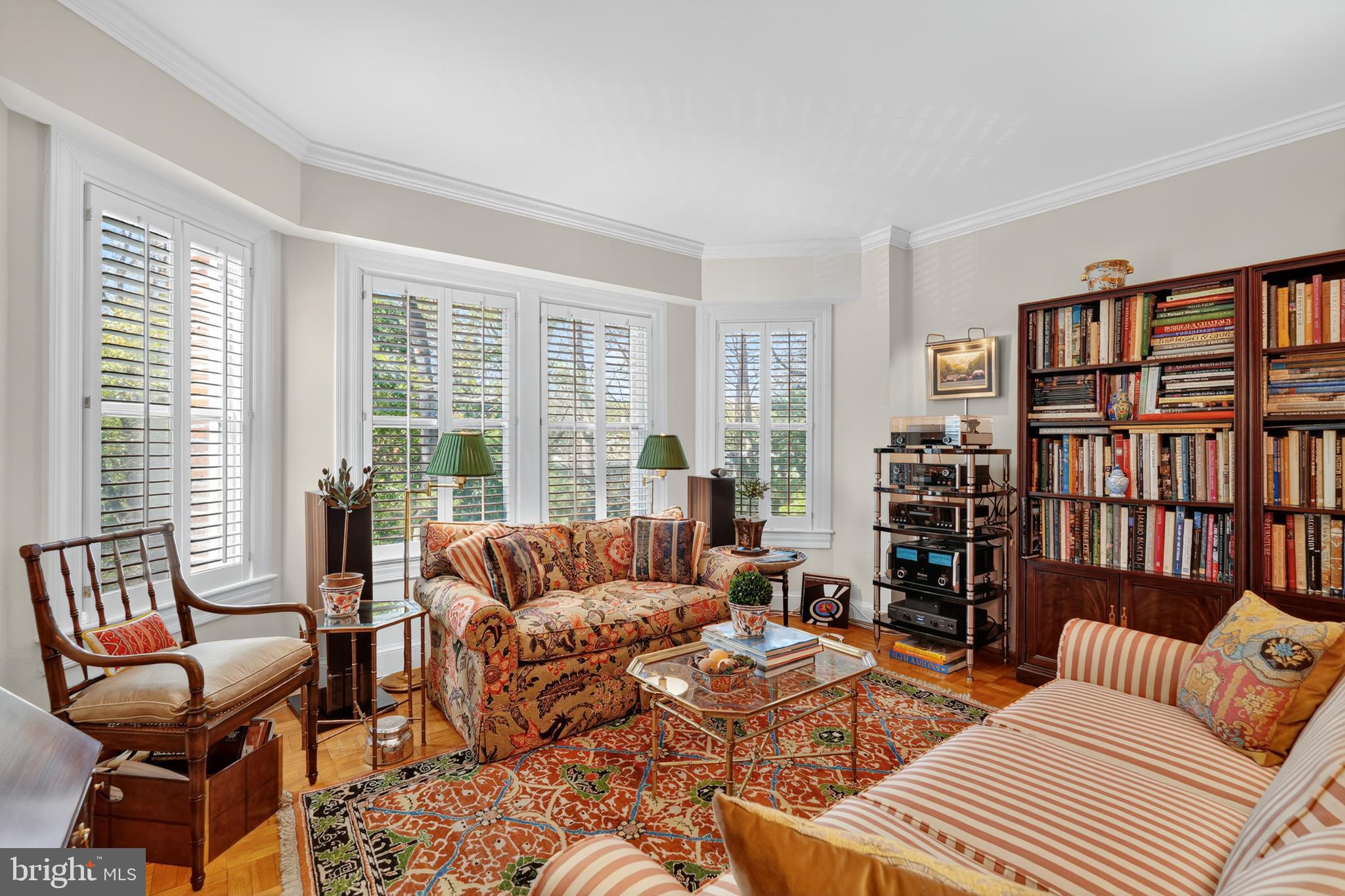 4000 Cathedral Avenue Northwest, Unit 17B Washington, DC 20016 - Photo 17 of 35 a living room with furniture and a book shelf