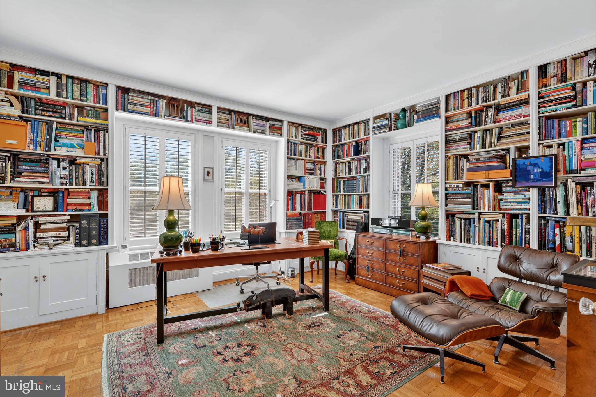 4000 Cathedral Avenue Northwest, Unit 17B Washington, DC 20016 - Photo 18 of 35 a living room with furniture and a book shelf