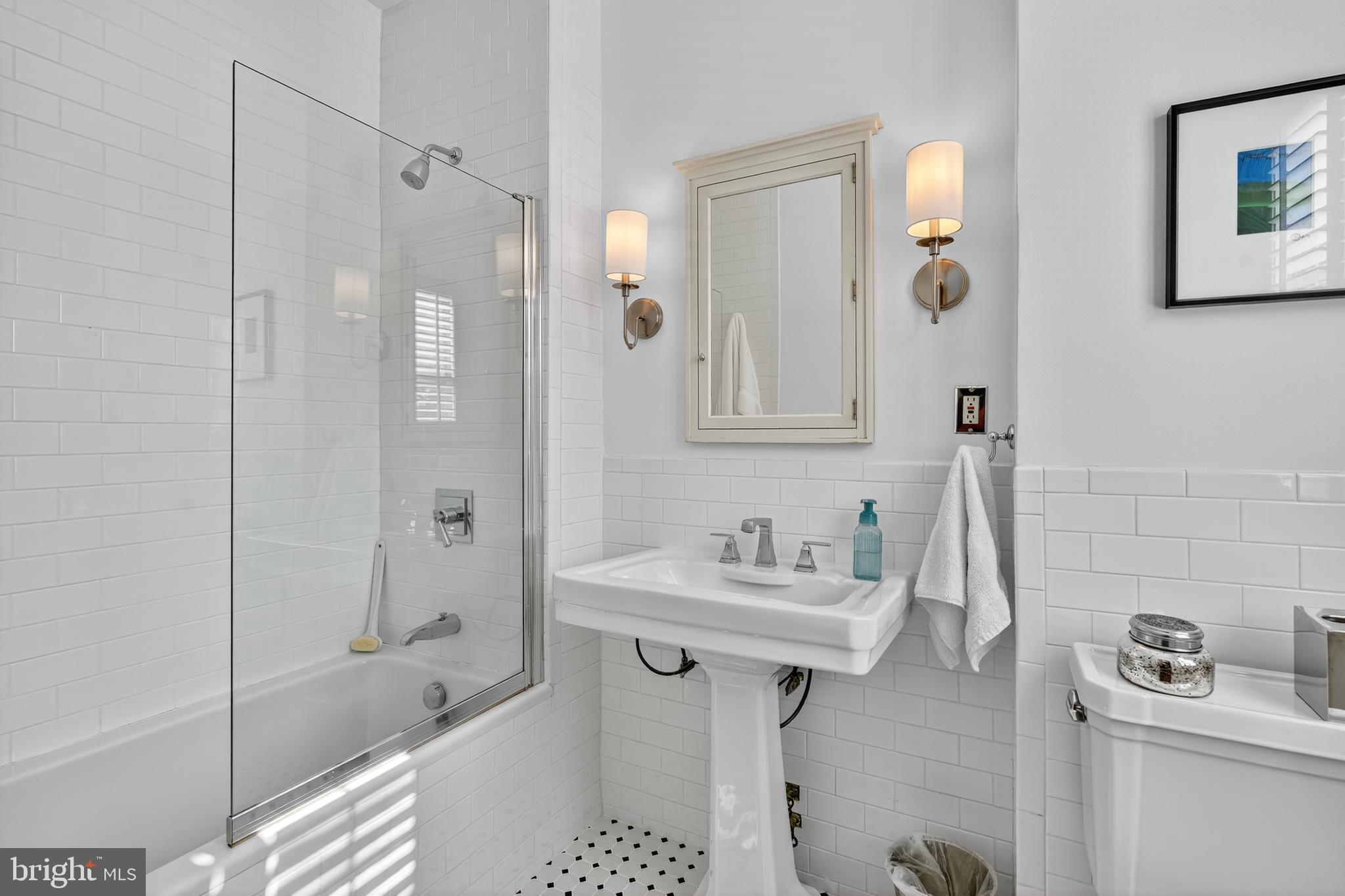 4000 Cathedral Avenue Northwest, Unit 17B Washington, DC 20016 - Photo 19 of 35 a bathroom with a sink a toilet and shower