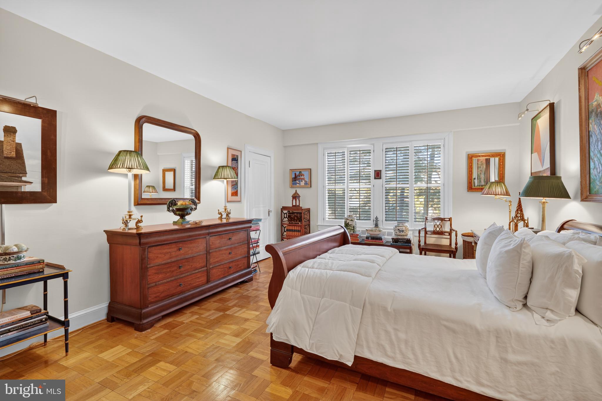 4000 Cathedral Avenue Northwest, Unit 17B Washington, DC 20016 - Photo 21 of 35 a bedroom with a bed large window and mirror