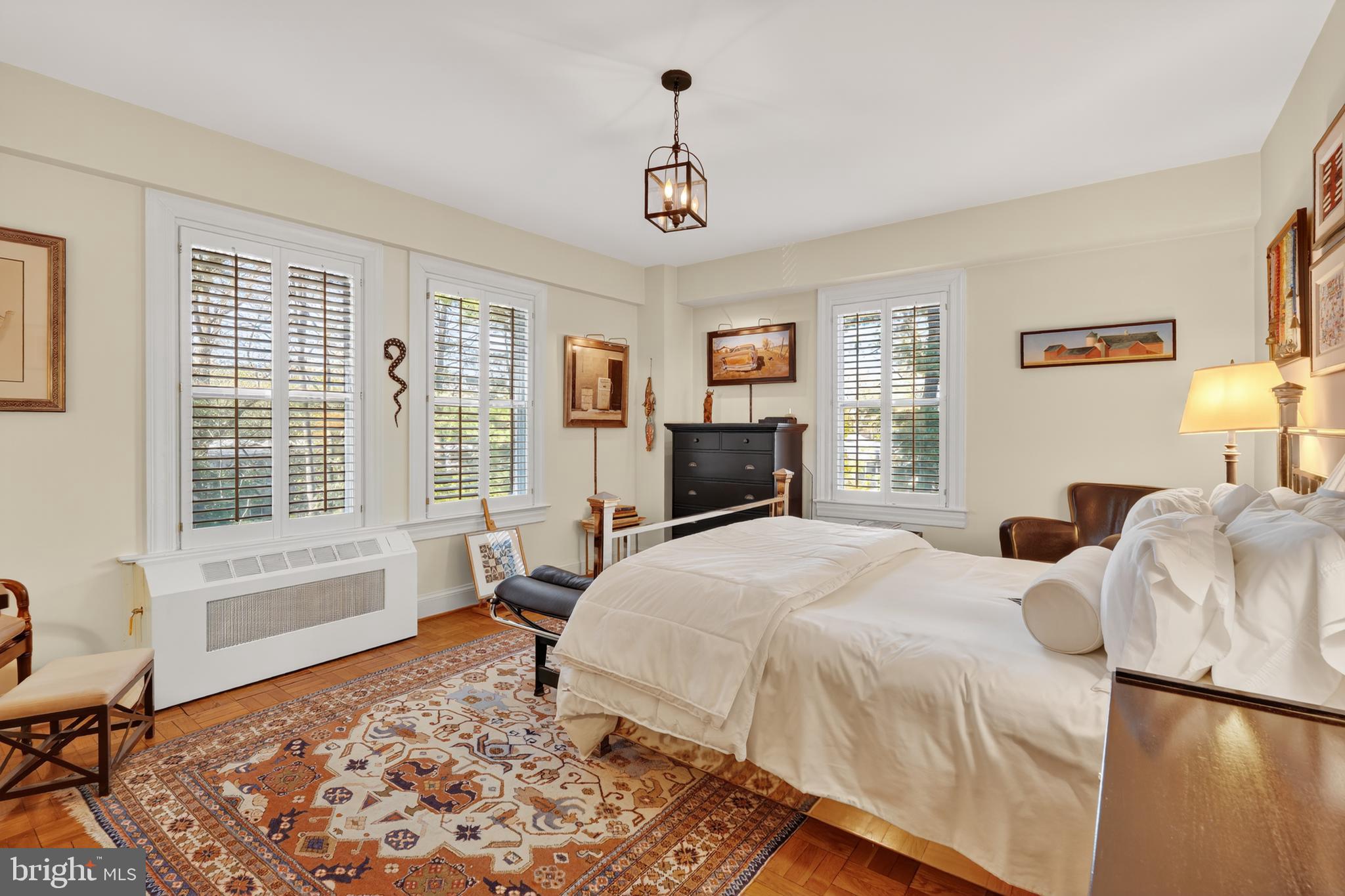 4000 Cathedral Avenue Northwest, Unit 17B Washington, DC 20016 - Photo 23 of 35 a bedroom with a bed couch and window
