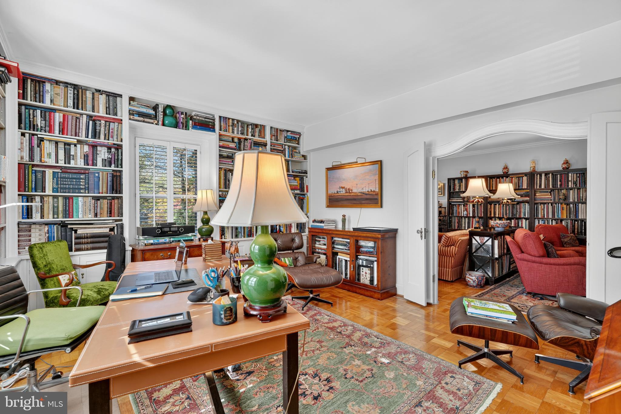 4000 Cathedral Avenue Northwest, Unit 17B Washington, DC 20016 - Photo 25 of 35 a living room with furniture a flat screen tv and a bookshelf