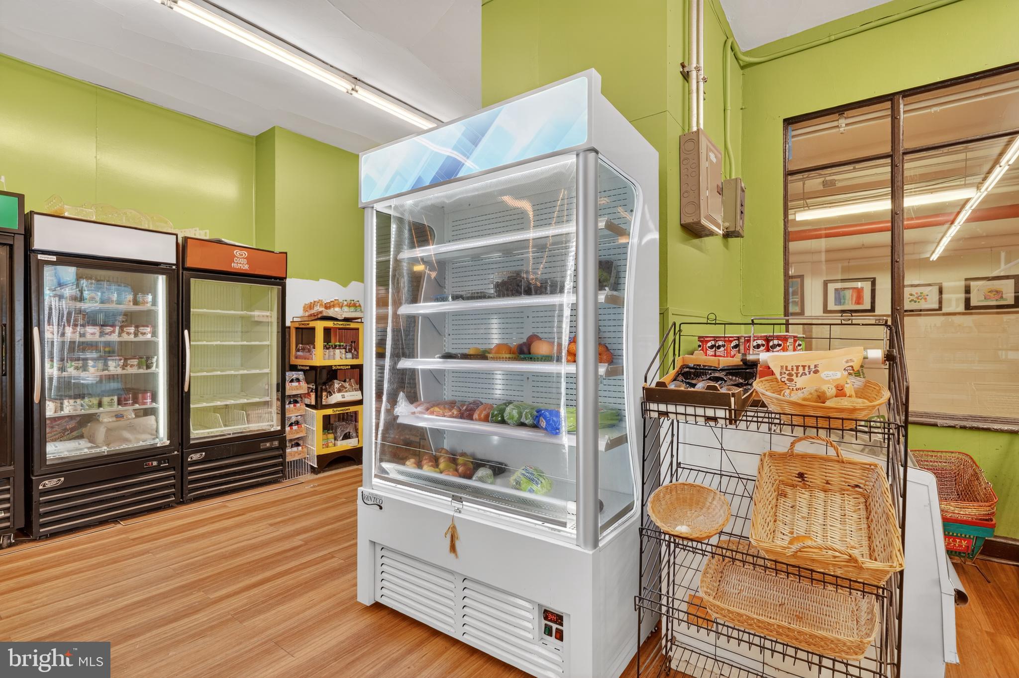 4000 Cathedral Avenue Northwest, Unit 17B Washington, DC 20016 - Photo 27 of 35 a kitchen with stainless steel appliances wooden floor and a large window