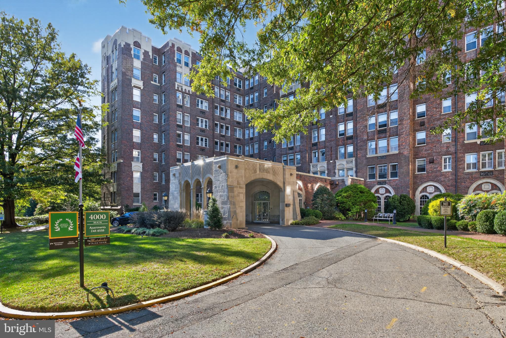 4000 Cathedral Avenue Northwest, Unit 17B Washington, DC 20016 - Photo 3 of 35 a view of a white building with a yard and plants