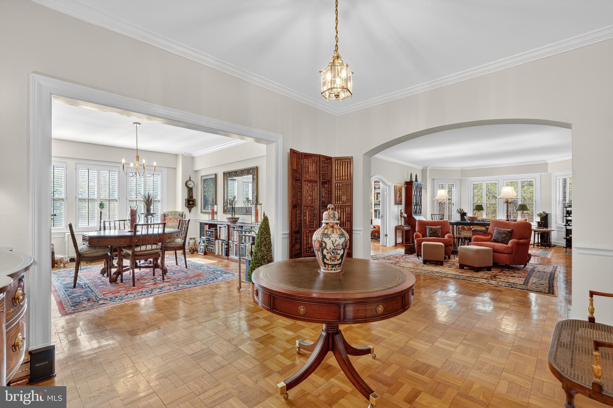 4000 Cathedral Avenue Northwest, Unit 17B Washington, DC 20016 - Photo 5 of 35 a living room with lots of furniture and a chandelier