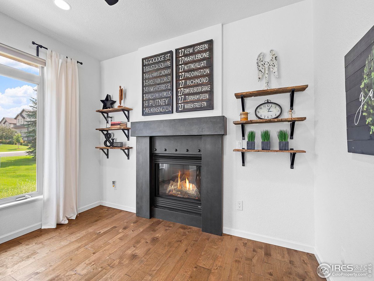 6427 Half Moon Bay Drive Windsor, CO 80550 - Photo 13 of 33 a view of an empty room with a fireplace and a window
