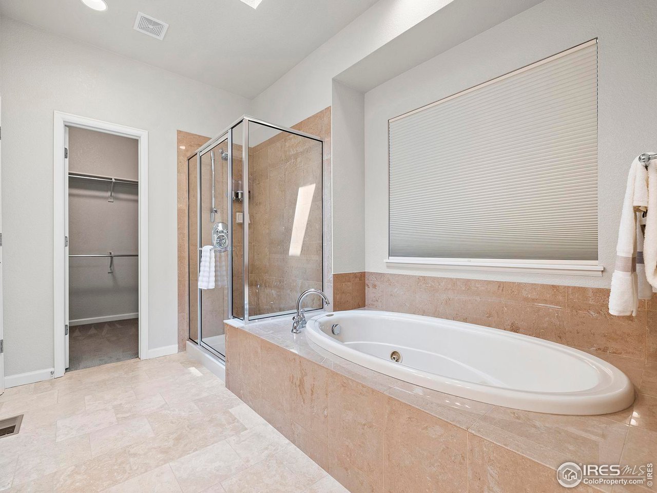 6427 Half Moon Bay Drive Windsor, CO 80550 - Photo 16 of 33 a bathroom with a bathtub and a shower