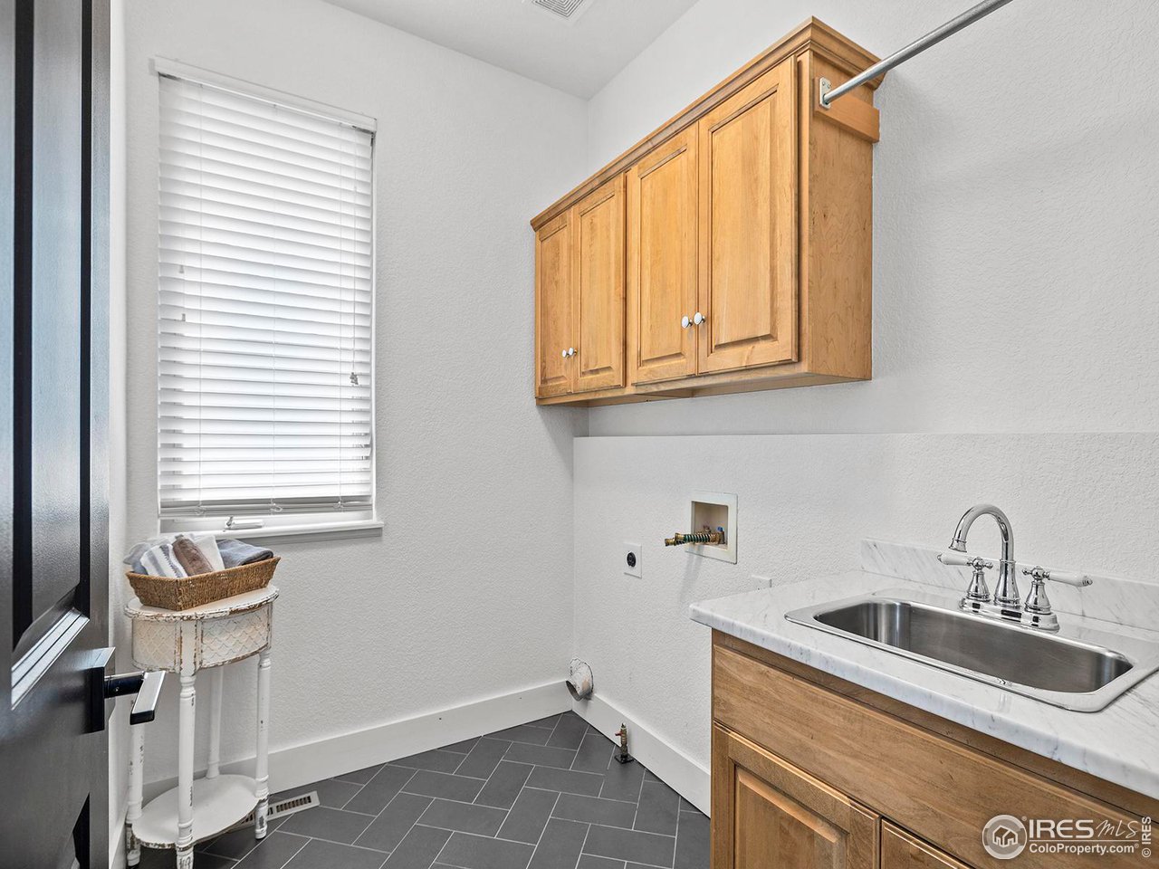 6427 Half Moon Bay Drive Windsor, CO 80550 - Photo 20 of 33 a bathroom with a sink and a window