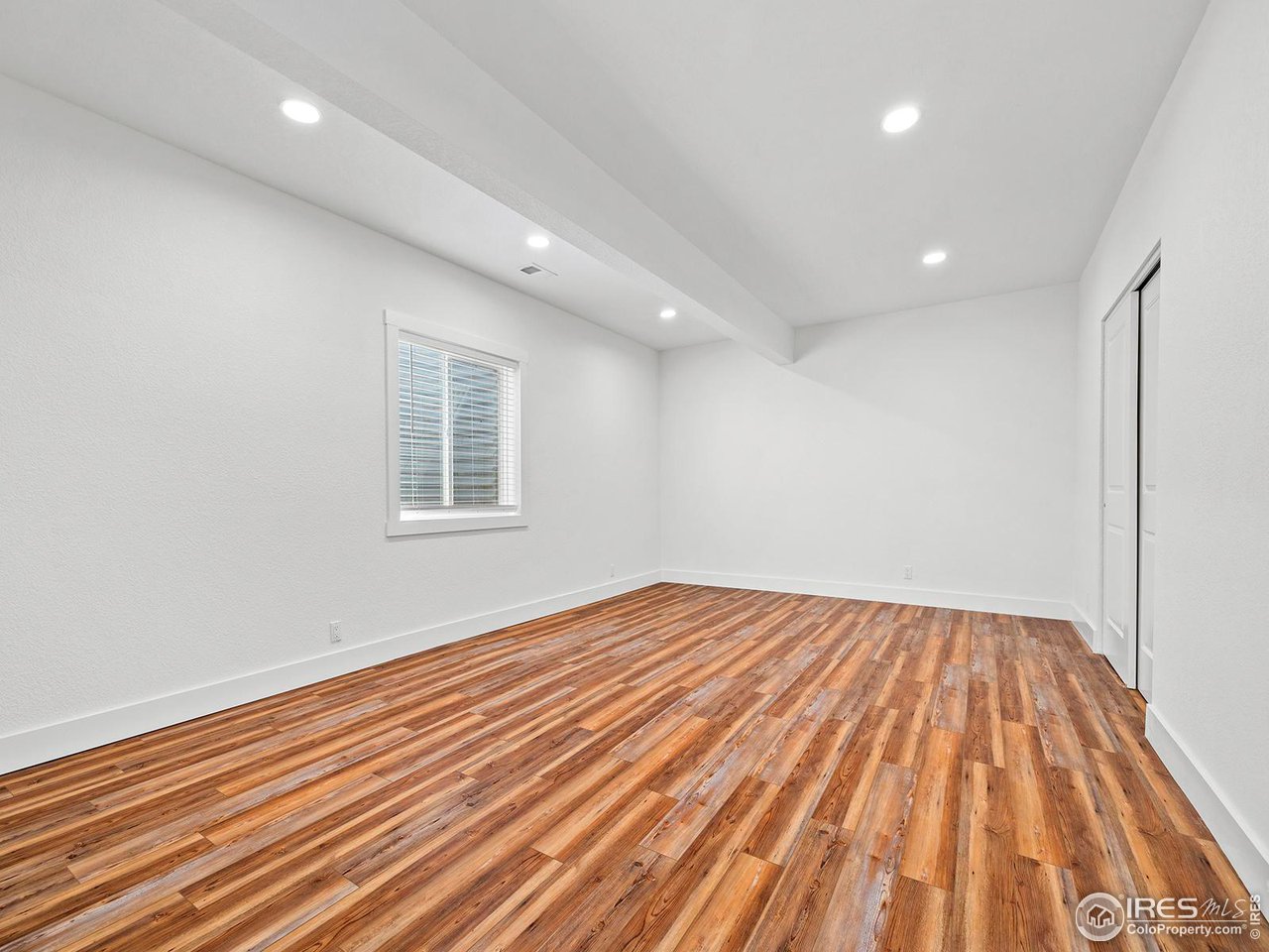 6427 Half Moon Bay Drive Windsor, CO 80550 - Photo 23 of 33 a view of empty room with wooden floor and fan