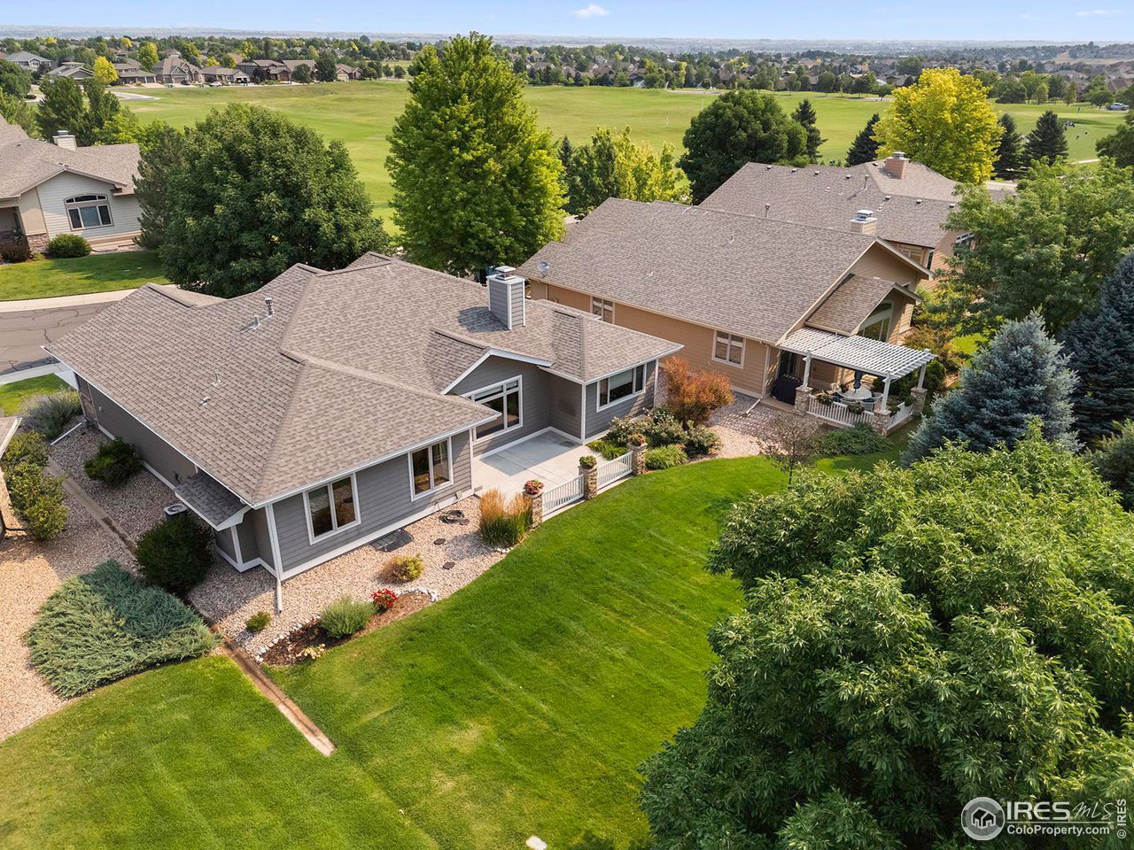 6427 Half Moon Bay Drive Windsor, CO 80550 - Photo 32 of 33 an aerial view of residential houses with outdoor space and trees