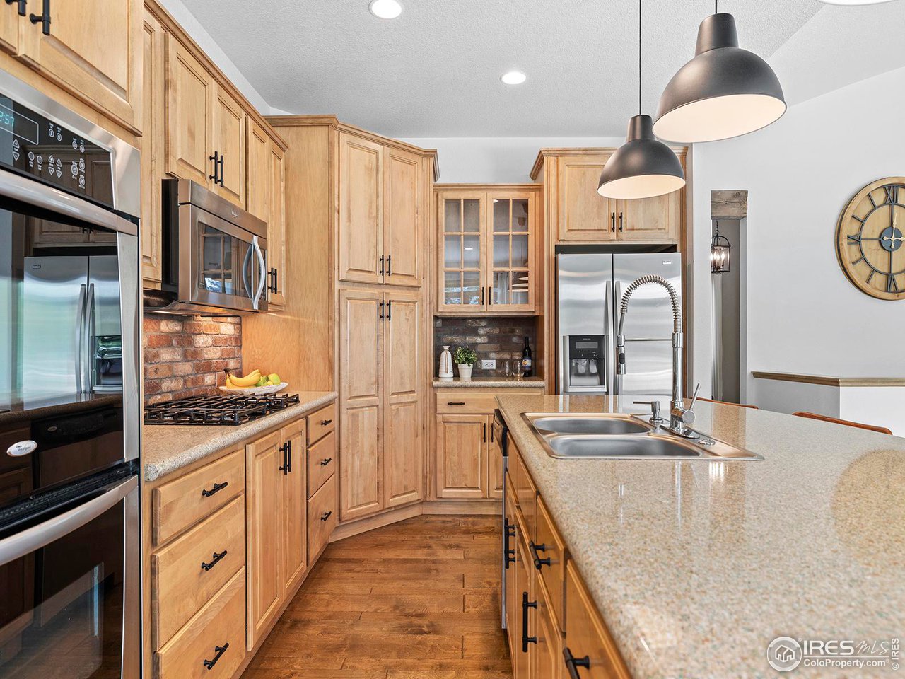 6427 Half Moon Bay Drive Windsor, CO 80550 - Photo 7 of 33 a kitchen with stainless steel appliances granite countertop a sink a stove and refrigerator