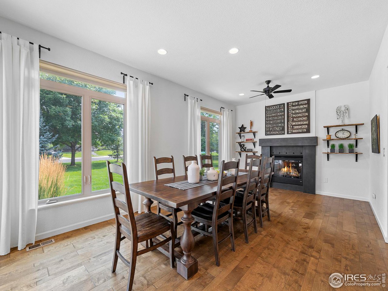 6427 Half Moon Bay Drive Windsor, CO 80550 - Photo 8 of 33 a view of a dining room with furniture window and wooden floor