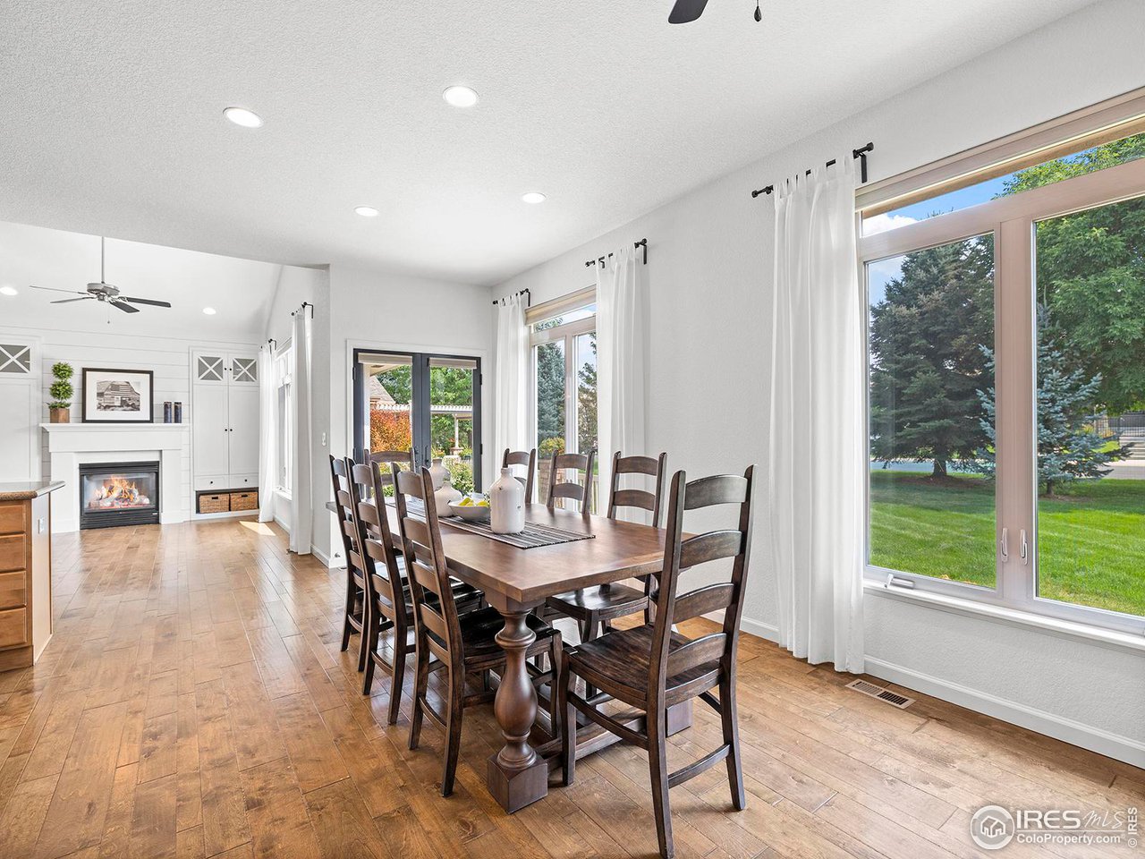 6427 Half Moon Bay Drive Windsor, CO 80550 - Photo 9 of 33 a view of a dining room with furniture window and wooden floor