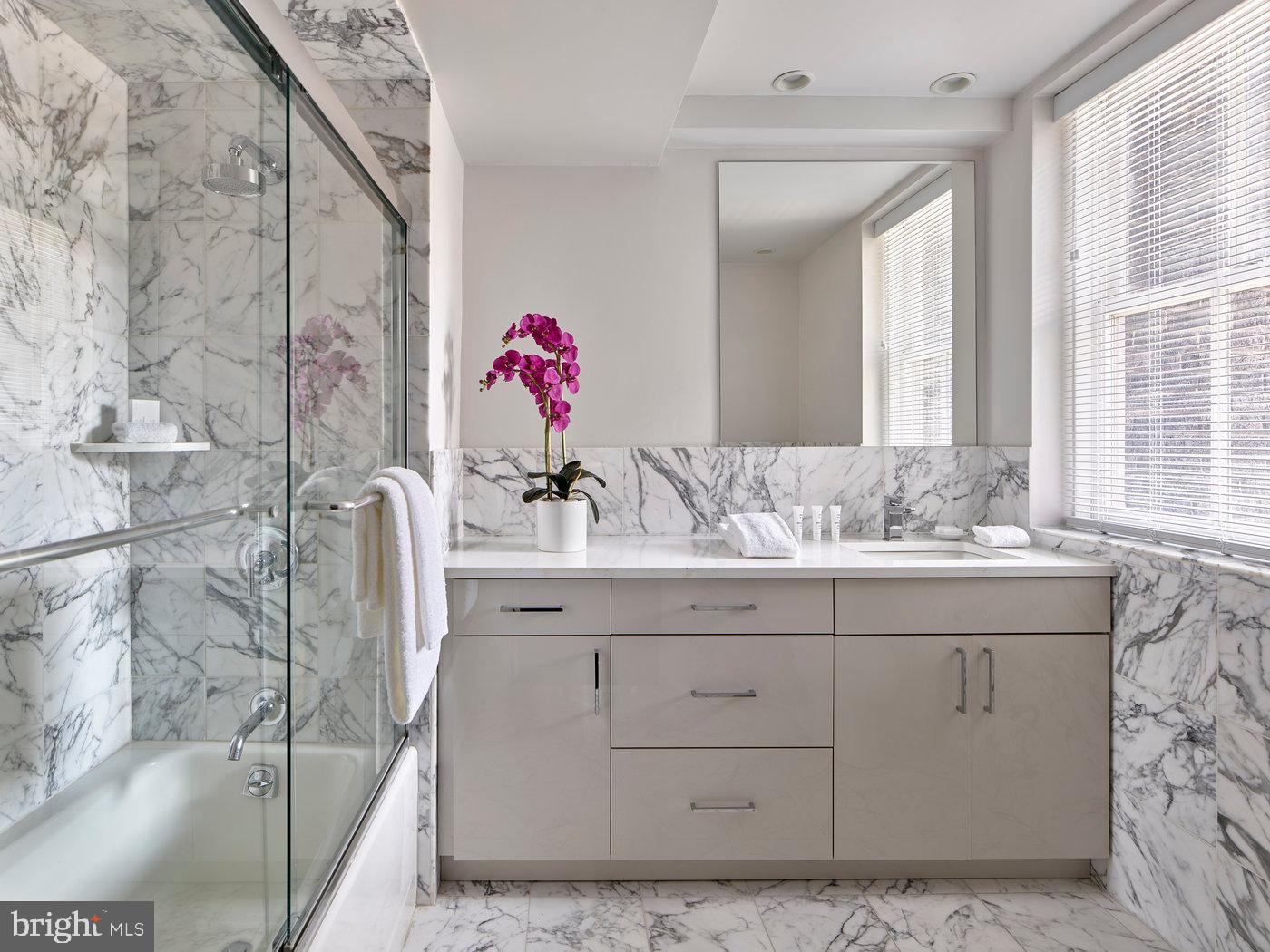 135 South 18th Street, Unit PLATINUM2BED Philadelphia, PA 19103 - Photo 5 of 12 a bathroom with a sink and a mirror