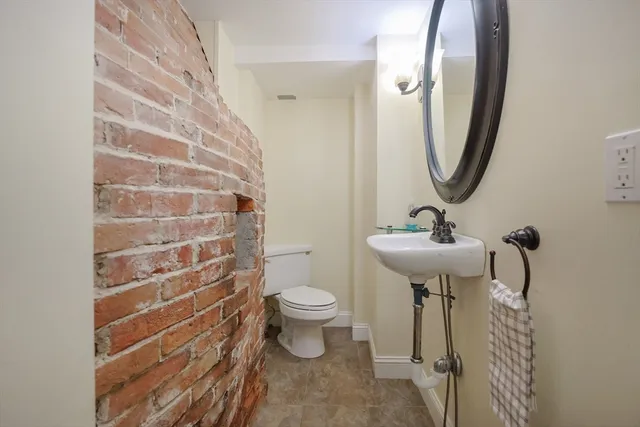 a bathroom with a sink toilet and a mirror