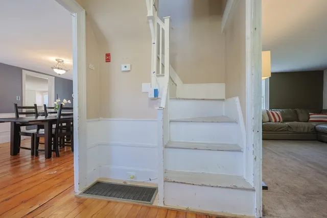 a view of a hallway view with wooden floor and staircase