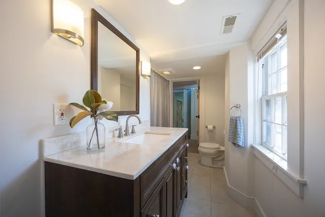 a kitchen with kitchen island a sink and a refrigerator
