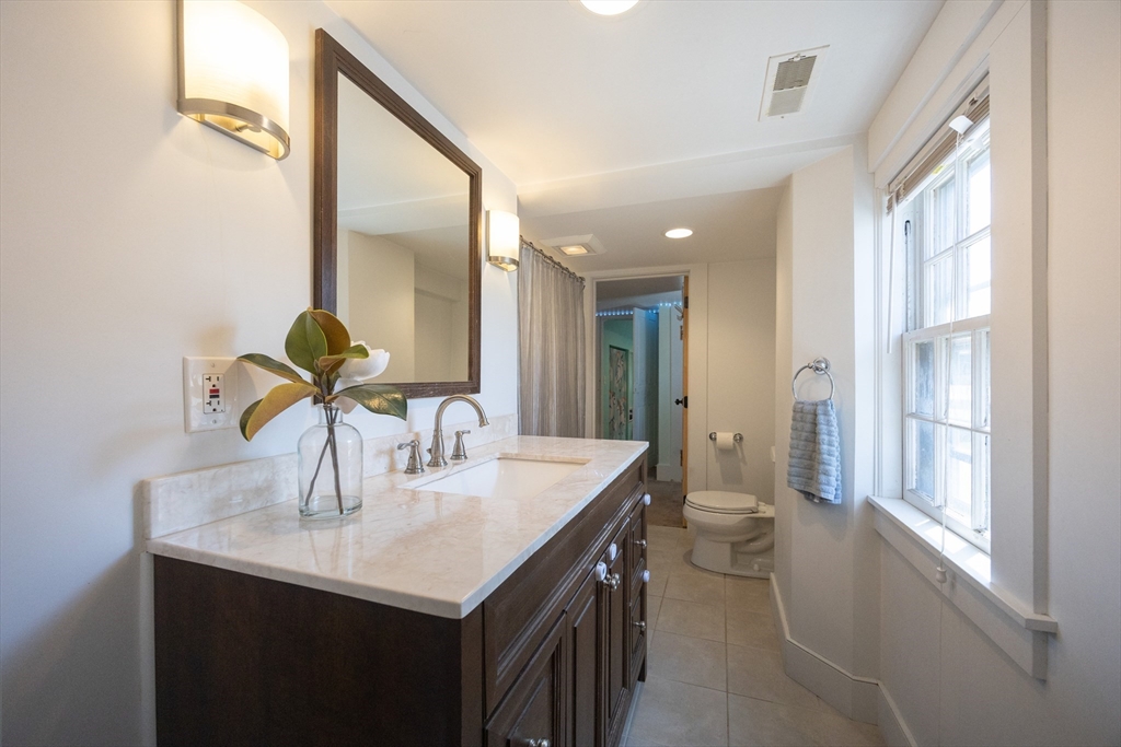137 High Street Danvers, MA 01923 - Photo 4 of 31 a kitchen with kitchen island a sink and a refrigerator