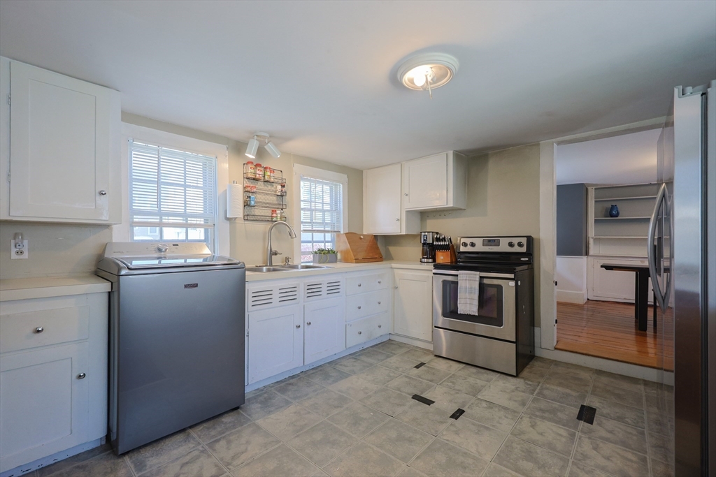 137 High Street Danvers, MA 01923 - Photo 5 of 31 a kitchen with granite countertop cabinets appliances and a window