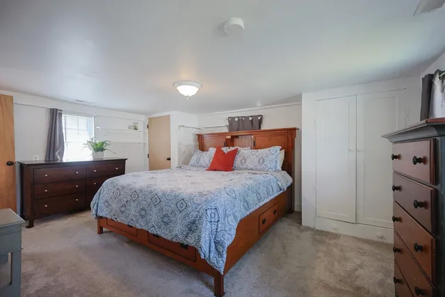 a bedroom with a bed and a dresser