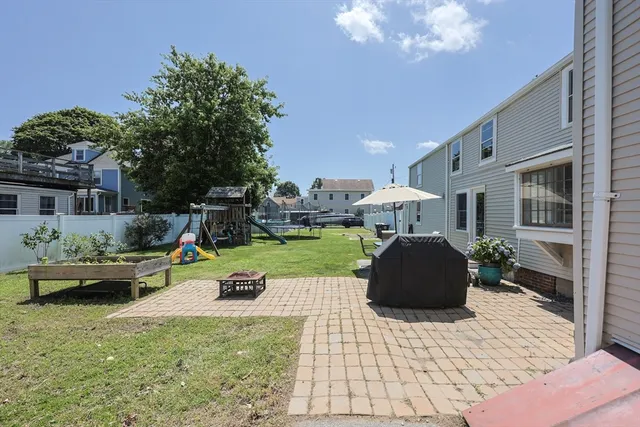 a front view of a house with sitting area and garden