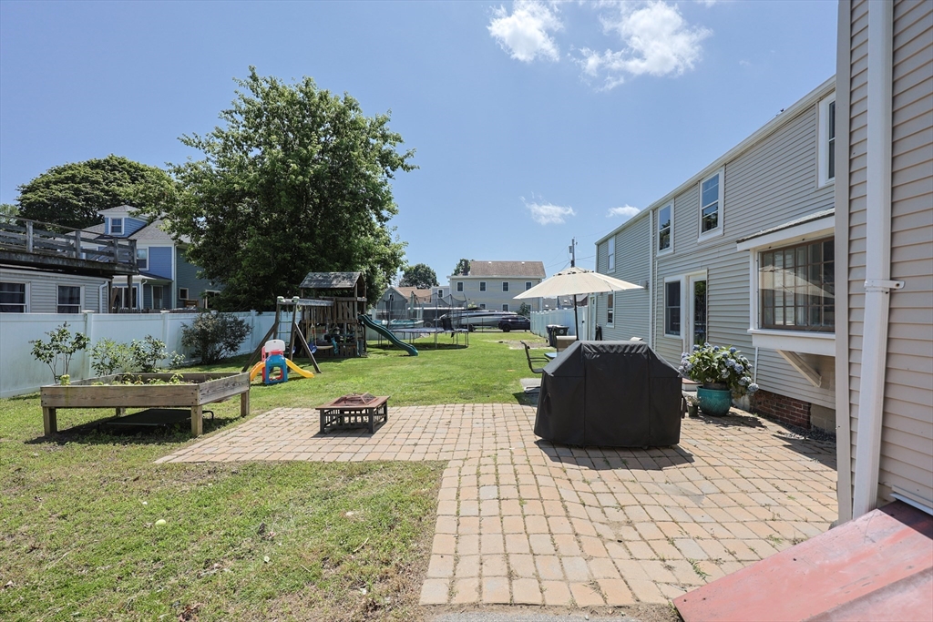 137 High Street Danvers, MA 01923 - Photo 9 of 31 a front view of a house with sitting area and garden