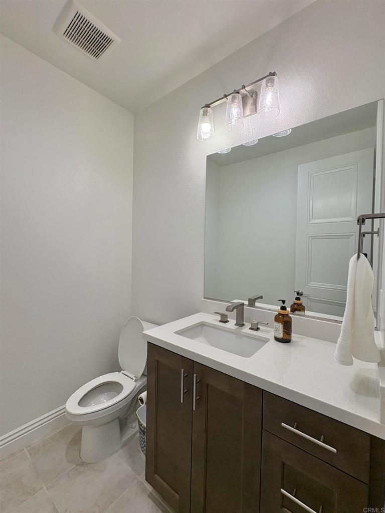 39529 Dayspring Way Temecula, CA 92591 - Photo 12 of 49 a bathroom with a sink a toilet and mirror