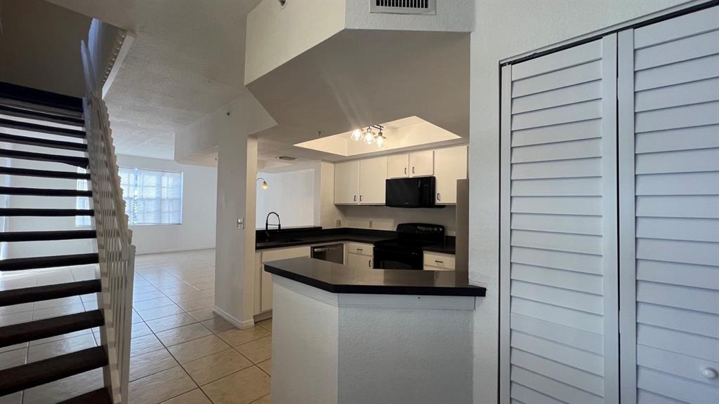 735 Southwest 148th Avenue, Unit 1702 Davie, FL 33325 - Photo 6 of 15 a kitchen with a refrigerator and a sink