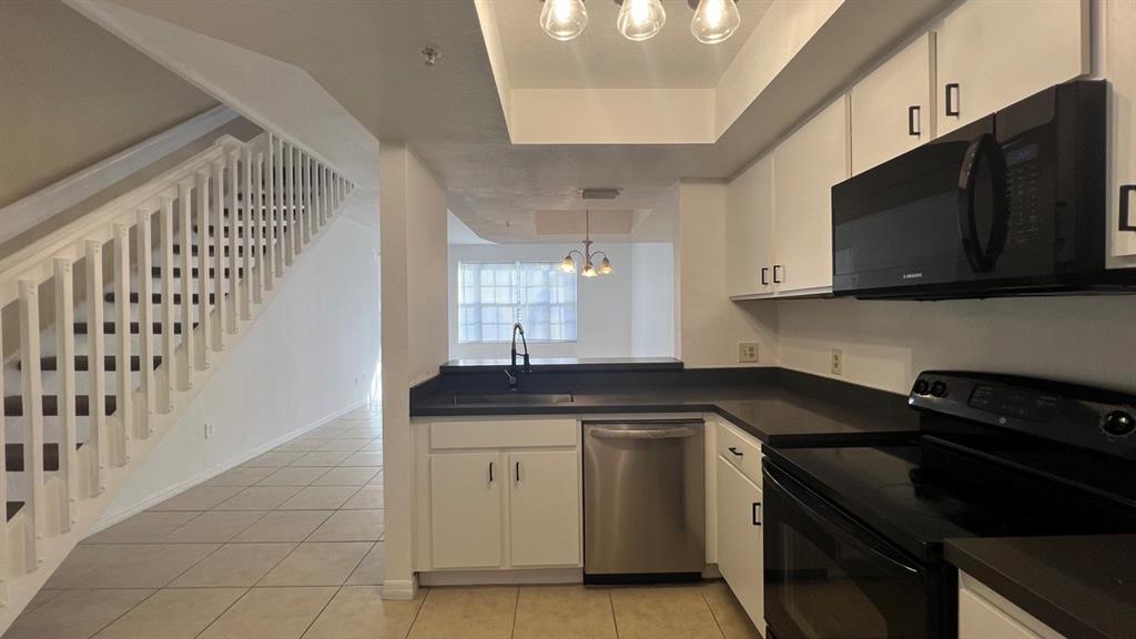 735 Southwest 148th Avenue, Unit 1702 Davie, FL 33325 - Photo 8 of 15 a kitchen with a sink stove and microwave