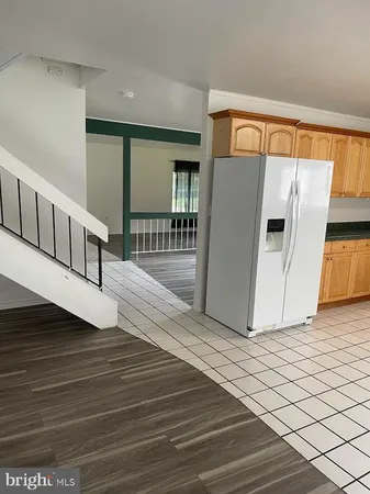 a kitchen with stainless steel appliances a refrigerator sink and microwave
