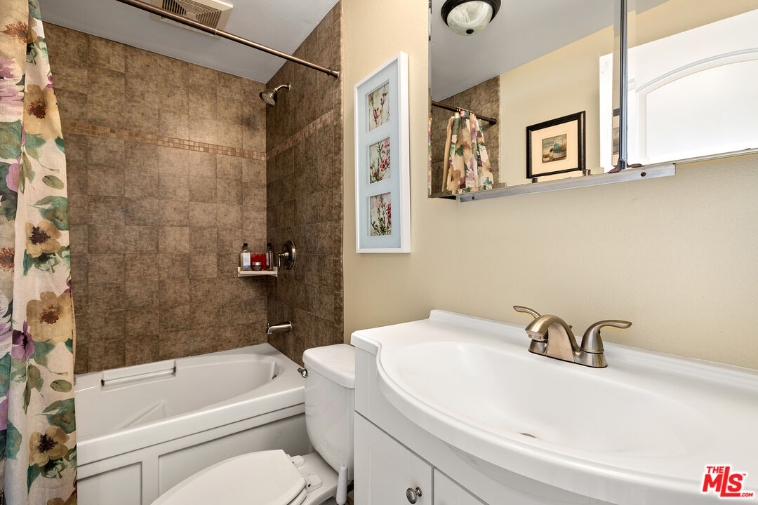 4230 Barrett Road Los Angeles, CA 90032 - Photo 17 of 28 a bathroom with a sink a toilet and a bathtub