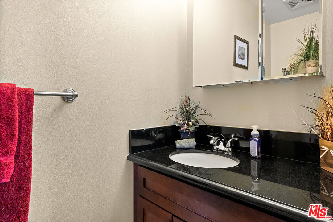 4230 Barrett Road Los Angeles, CA 90032 - Photo 18 of 28 a bathroom with a sink and a mirror