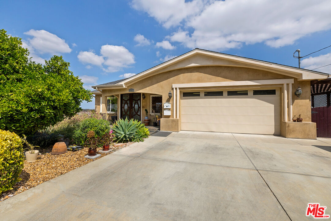 4230 Barrett Road Los Angeles, CA 90032 - Photo 2 of 28 a front view of a house with a yard and garage