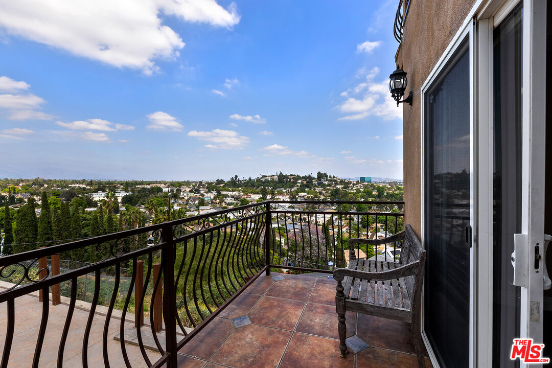 4230 Barrett Road Los Angeles, CA 90032 - Photo 27 of 28 a view of a balcony with wooden chairs and floor to ceiling window