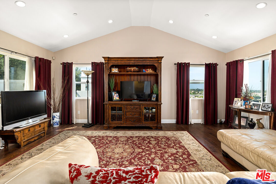 4230 Barrett Road Los Angeles, CA 90032 - Photo 4 of 28 a bedroom with furniture and flat screen tv