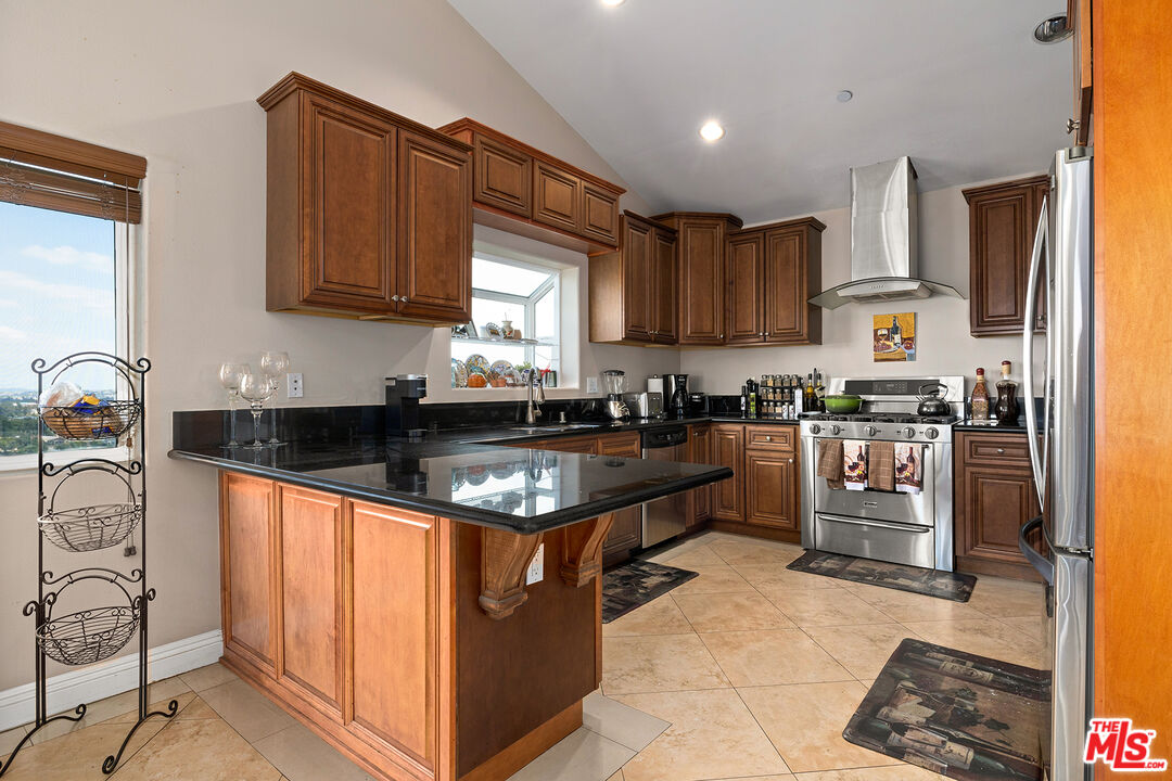 4230 Barrett Road Los Angeles, CA 90032 - Photo 7 of 28 a kitchen with stainless steel appliances granite countertop a stove a sink and a microwave