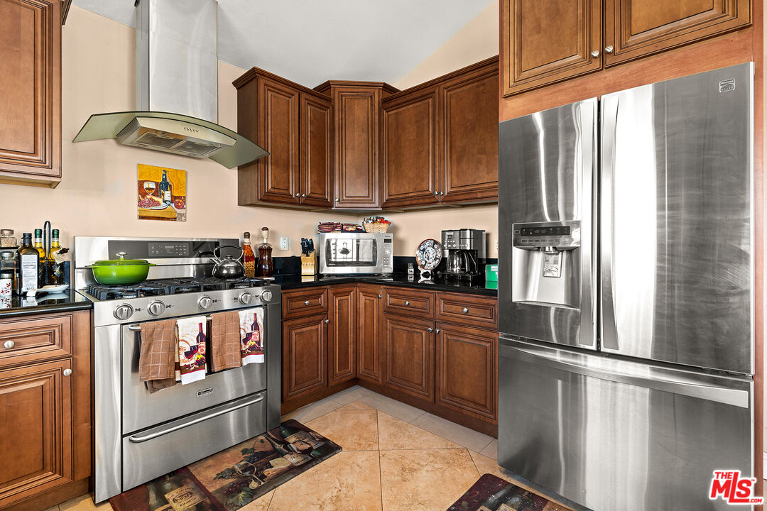 4230 Barrett Road Los Angeles, CA 90032 - Photo 9 of 28 a kitchen with stainless steel appliances granite countertop a refrigerator and a stove top oven