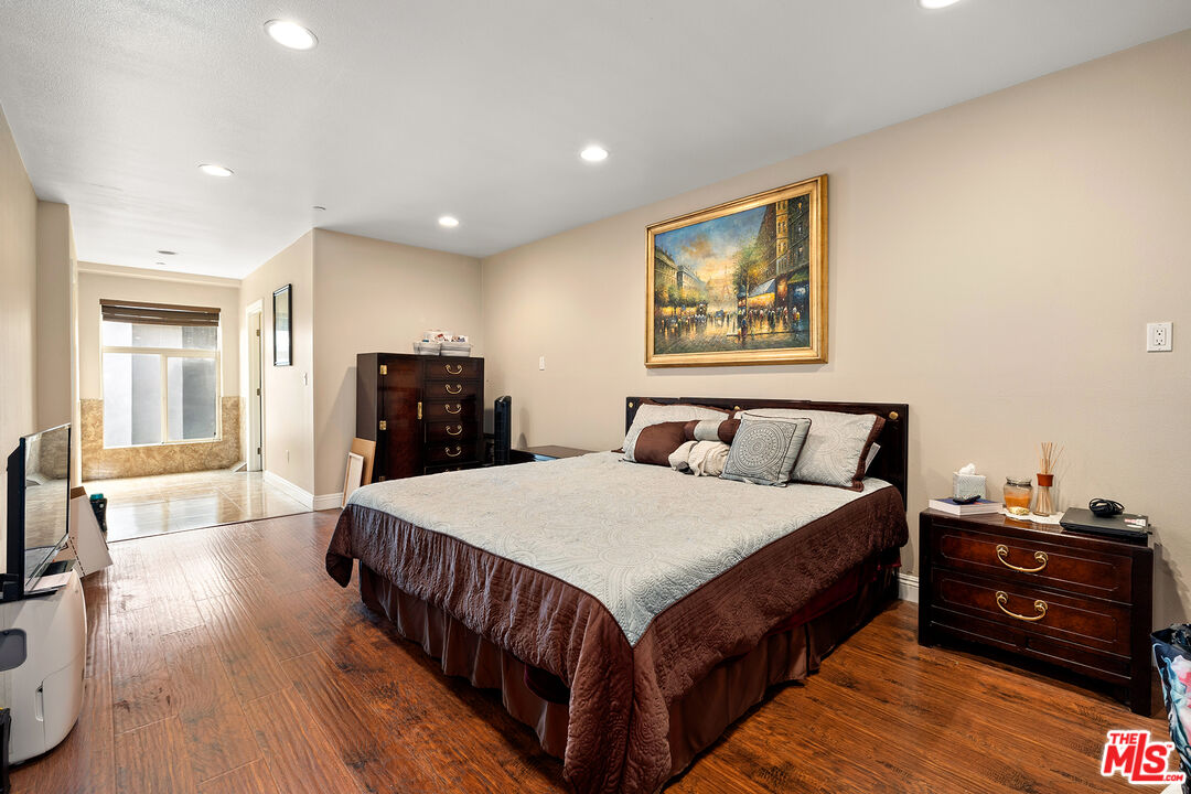 4230 Barrett Road Los Angeles, CA 90032 - Photo 10 of 28 a bedroom with a bed and wooden floor