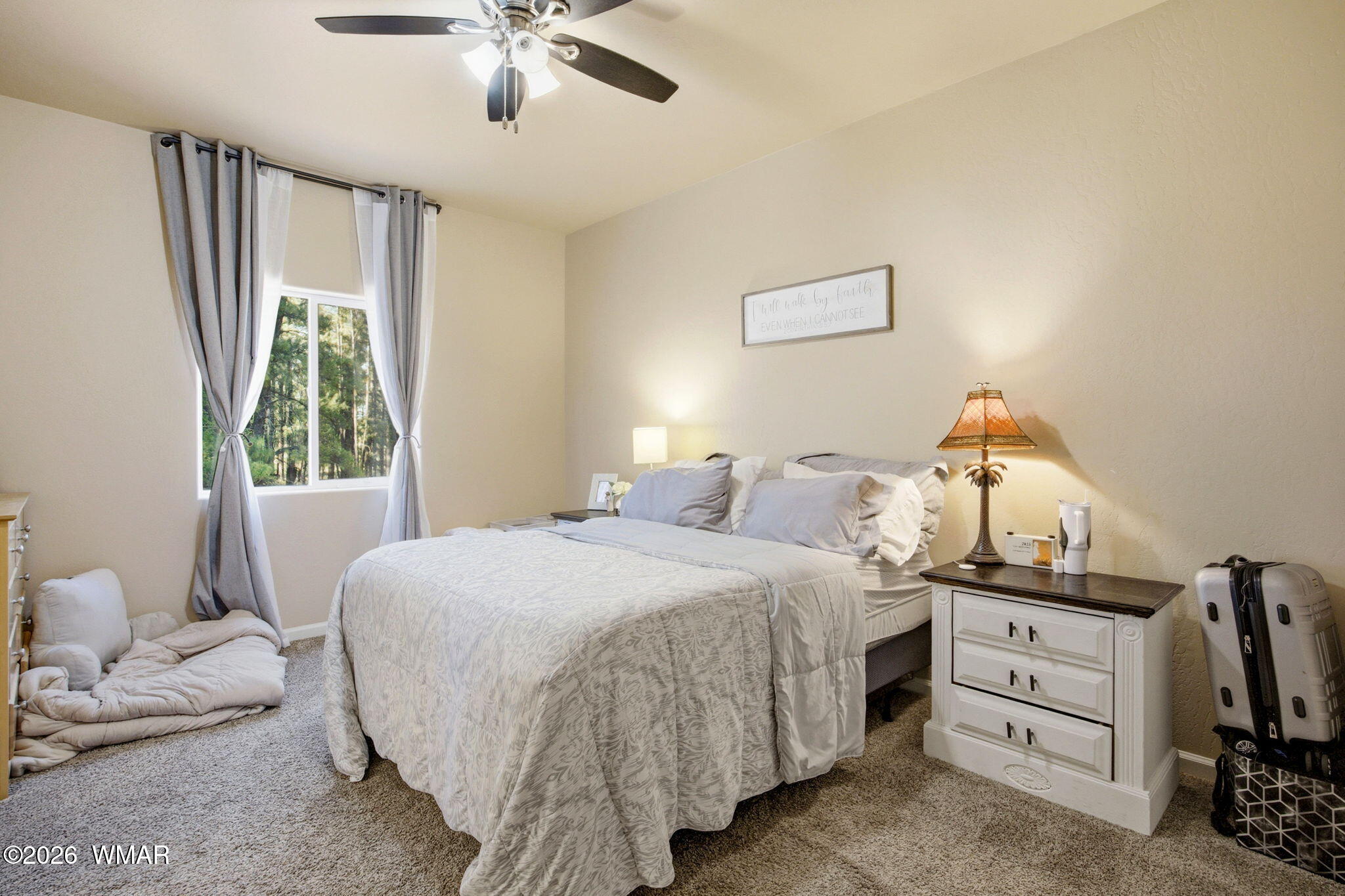 588 Rim Road Pinedale, AZ 85934 - Photo 14 of 30 a bedroom with a bed and a chandelier