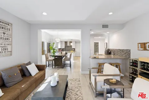 a spacious bedroom with a bed and glass table