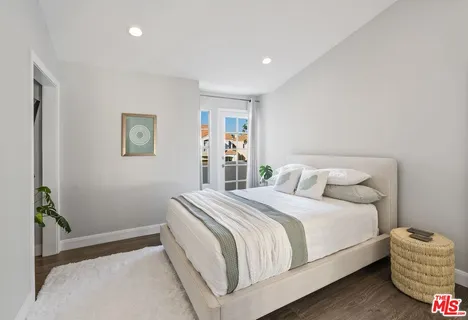 a front view of a house with plants and entryway