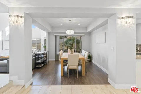a view of a dining room with furniture and a potted plant
