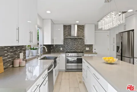 a living room with furniture and a dining table with kitchen view