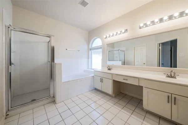 a large bathroom with a double vanity sink mirror and shower