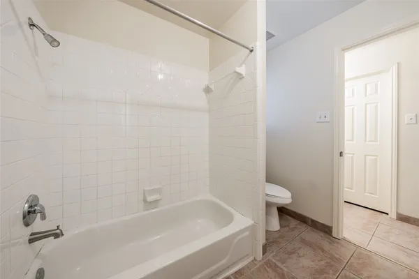 a bathroom with a bathtub and toilet