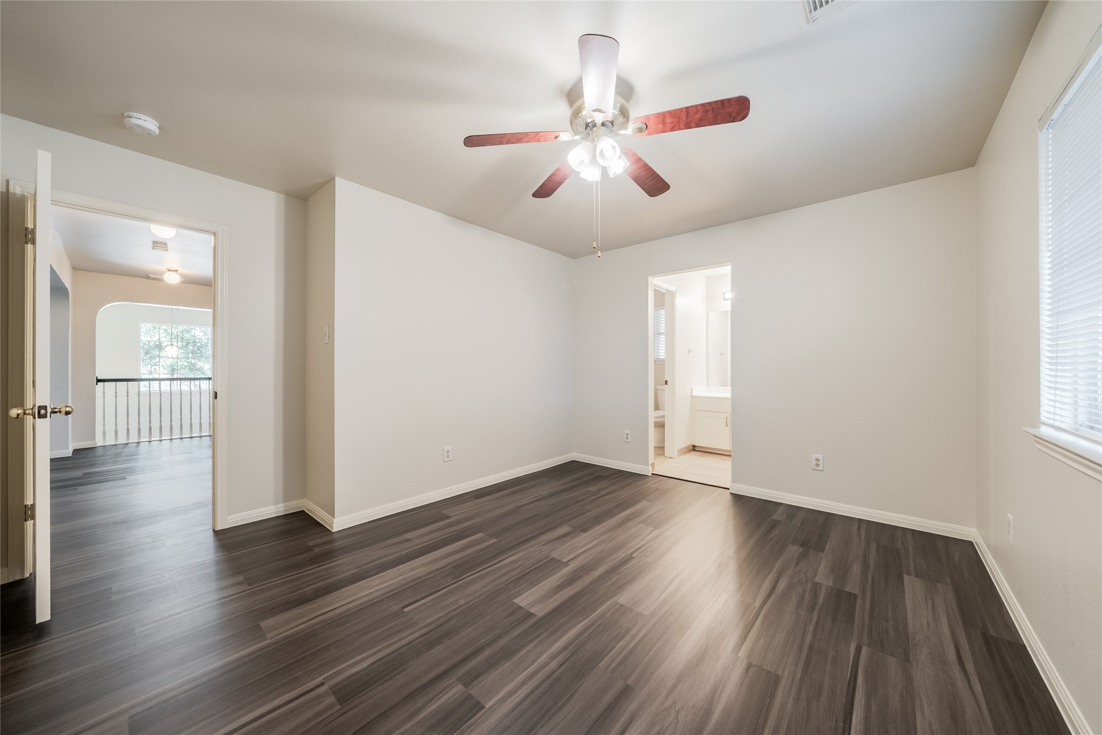 915 Double File Trail Round Rock, TX 78665 - Photo 29 of 32 a view of an empty room with wooden floor and a window