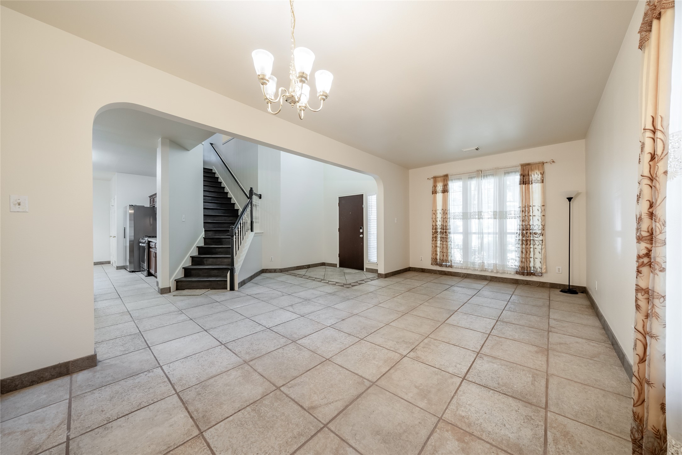 915 Double File Trail Round Rock, TX 78665 - Photo 3 of 32 an empty room with fireplace and windows