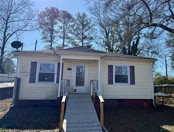 a view of a house with a large tree