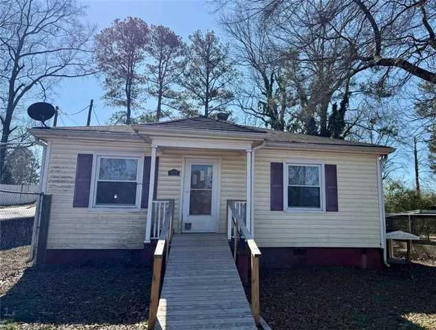 a view of a house with a large tree