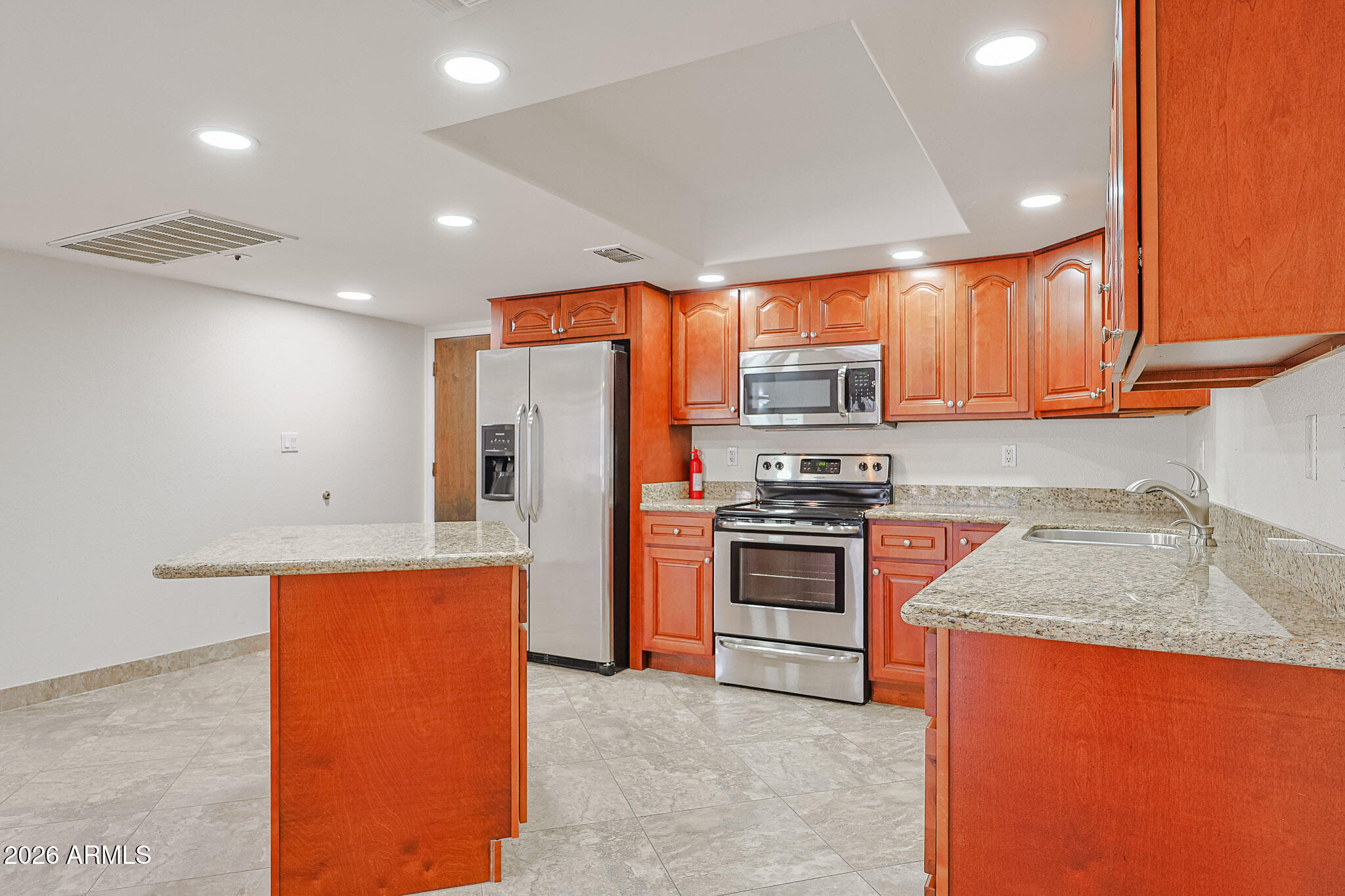 7920 East Camelback Road, Unit 111 Scottsdale, AZ 85251 - Photo 7 of 32 a kitchen with stainless steel appliances granite countertop a refrigerator sink and stove